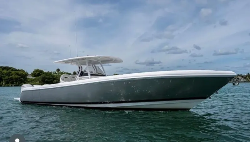 Towa VII Yacht Photos Pics 2016 Intrepid 375 Center Console boat on water under cloudy sky.