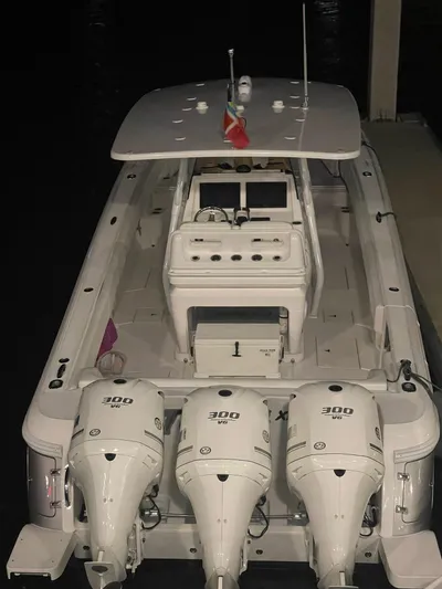 Towa VII Yacht Photos Pics 2016 Intrepid 375 Center Console boat with triple 300 horsepower engines docked at night.