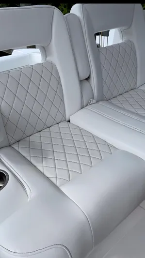 Towa VII Yacht Photos Pics 2016 Intrepid 375 Center Console boat with white diamond-stitched seating.