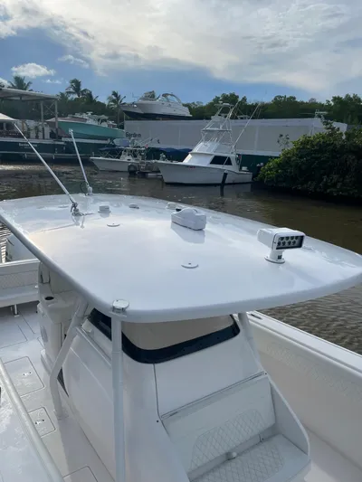 Towa VII Yacht Photos Pics 2016 Intrepid 375 Center Console boat docked near other vessels.