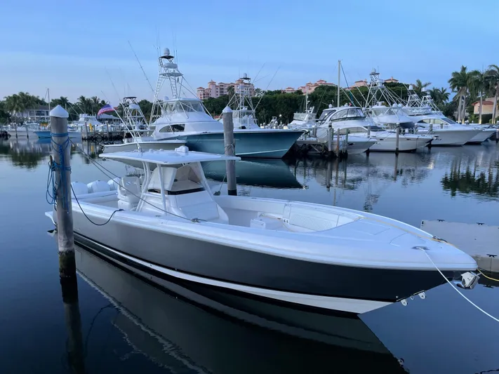Towa VII Yacht Photos Pics 2016 Intrepid 375 Center Console boat docked in a marina.