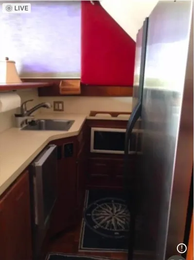 Double Deese Yacht Photos Pics Compact kitchen in a 1989 Viking fish model boat with modern appliances.