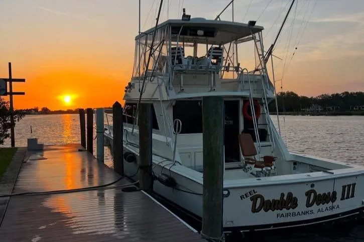 Double Deese Yacht Photos Pics 1989 Viking fish boat docked at sunset, serene waterfront view.