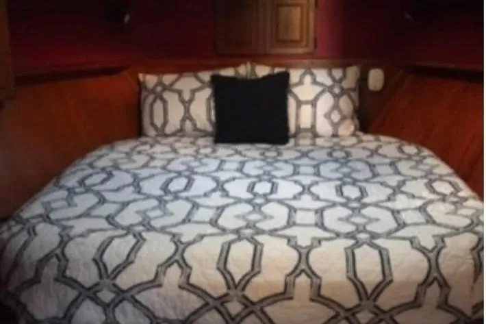 Double Deese Yacht Photos Pics Cozy bedroom in 1989 Viking fish model with patterned bedding and wooden accents.