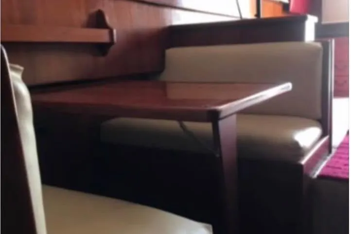 Double Deese Yacht Photos Pics 1989 Viking Fish boat interior with wooden table and cushioned seating.