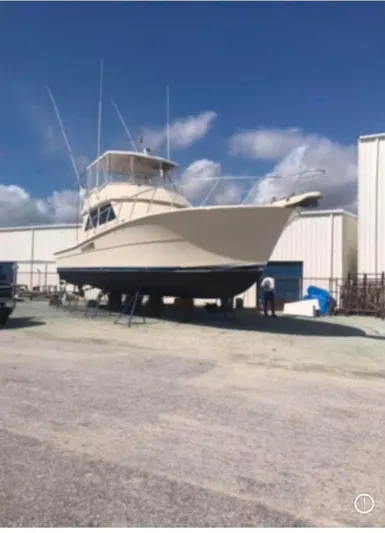 Double Deese Yacht Photos Pics 1989 Viking fish boat on dry dock under a clear blue sky.