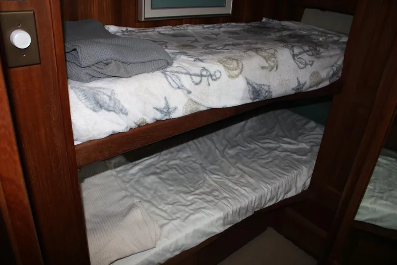 Double Deese Yacht Photos Pics Bunk beds in a 1989 Viking Fish boat cabin with nautical-themed bedding.