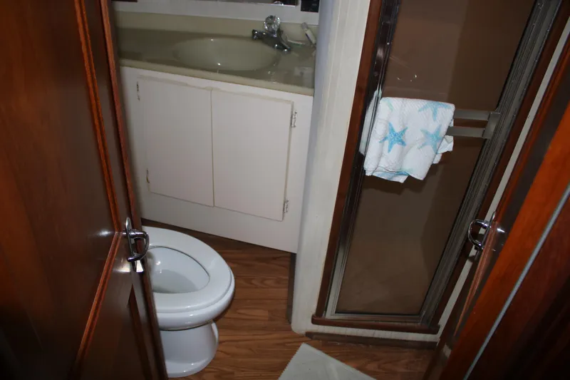 Double Deese Yacht Photos Pics 1989 Viking fish model bathroom with toilet, sink, and shower.