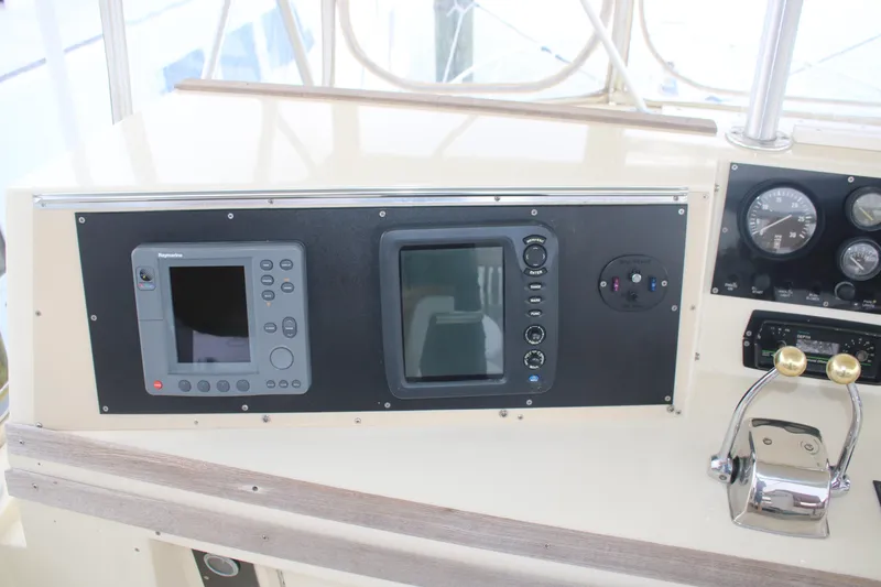 Double Deese Yacht Photos Pics Control panel of a 1989 Viking fish boat with navigation instruments and throttle controls.