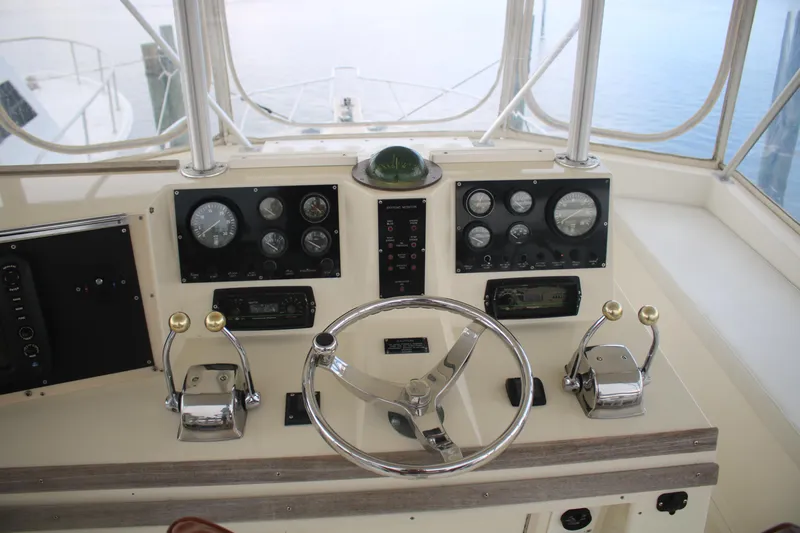 Double Deese Yacht Photos Pics 1989 Viking fish boat helm with steering wheel and control panels.