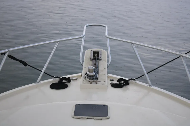 Double Deese Yacht Photos Pics Bow of a 1989 Viking fish boat on calm water.