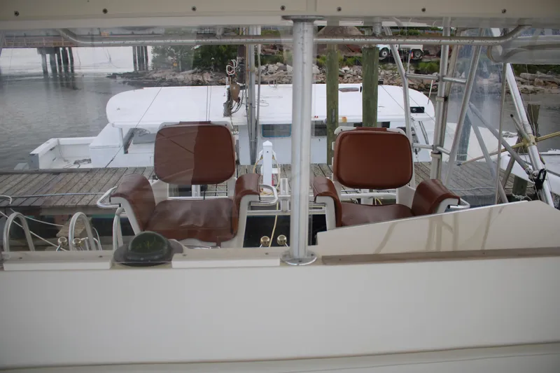 Double Deese Yacht Photos Pics 1989 Viking fish boat interior with brown seats and steering area.