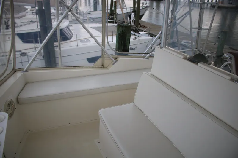 Double Deese Yacht Photos Pics 1989 Viking fish boat interior with white seating and marina view.