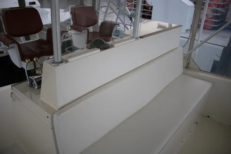 Double Deese Yacht Photos Pics 1989 Viking Fish boat interior with white seating and brown chairs.