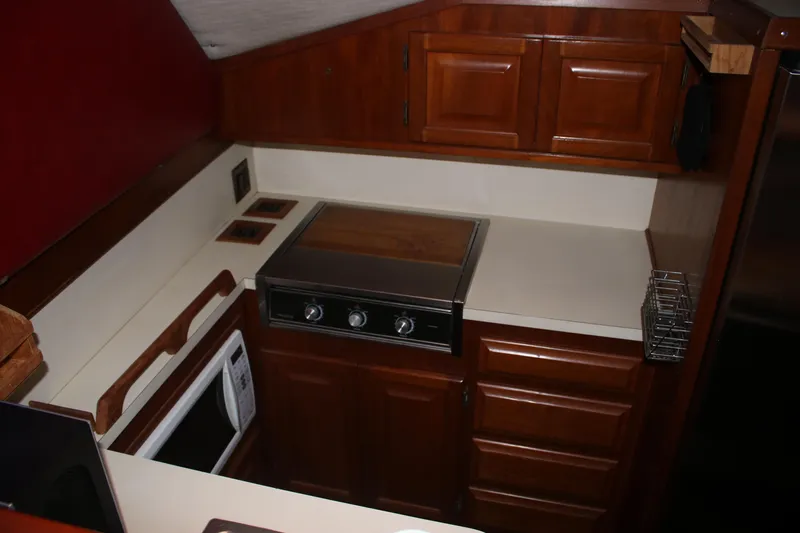 Double Deese Yacht Photos Pics 1989 Viking Fish model kitchen with wooden cabinets and modern appliances.