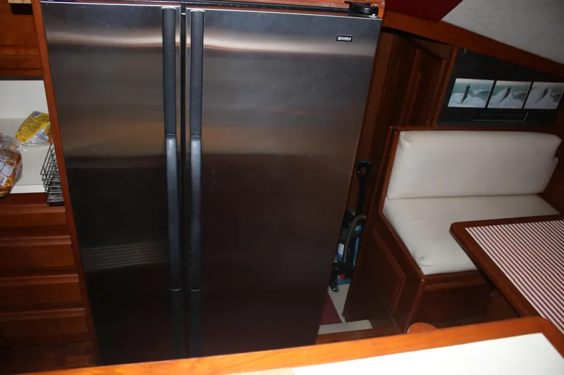 Double Deese Yacht Photos Pics 1989 Viking fish model interior with stainless steel fridge and cozy dining area.