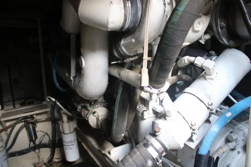 Double Deese Yacht Photos Pics Engine room of a 1989 Viking fish boat, showcasing complex machinery and hoses.