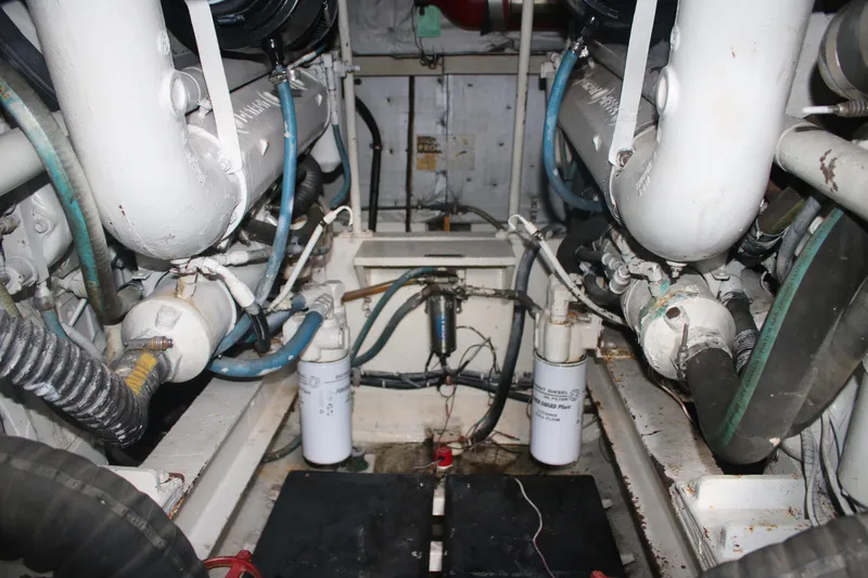 Double Deese Yacht Photos Pics Engine room of a 1989 Viking fish model boat, showcasing mechanical components and pipes.