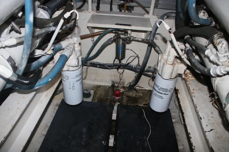 Double Deese Yacht Photos Pics Engine compartment of a 1989 Viking fish model with visible oil filters and hoses.