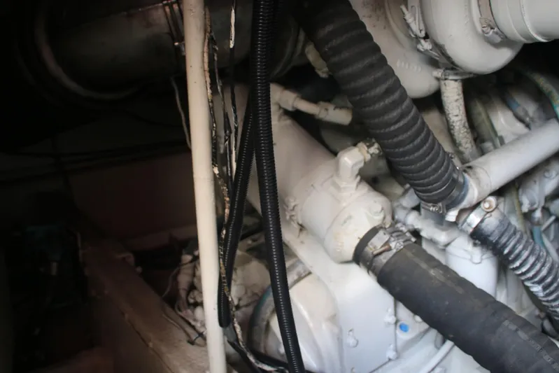 Double Deese Yacht Photos Pics Engine compartment of a 1989 Viking fish boat, showing hoses and mechanical components.