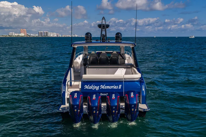  Yacht Photos Pics Azimut Verve 47 yacht, 2022 model, cruising on open water with city skyline in background.