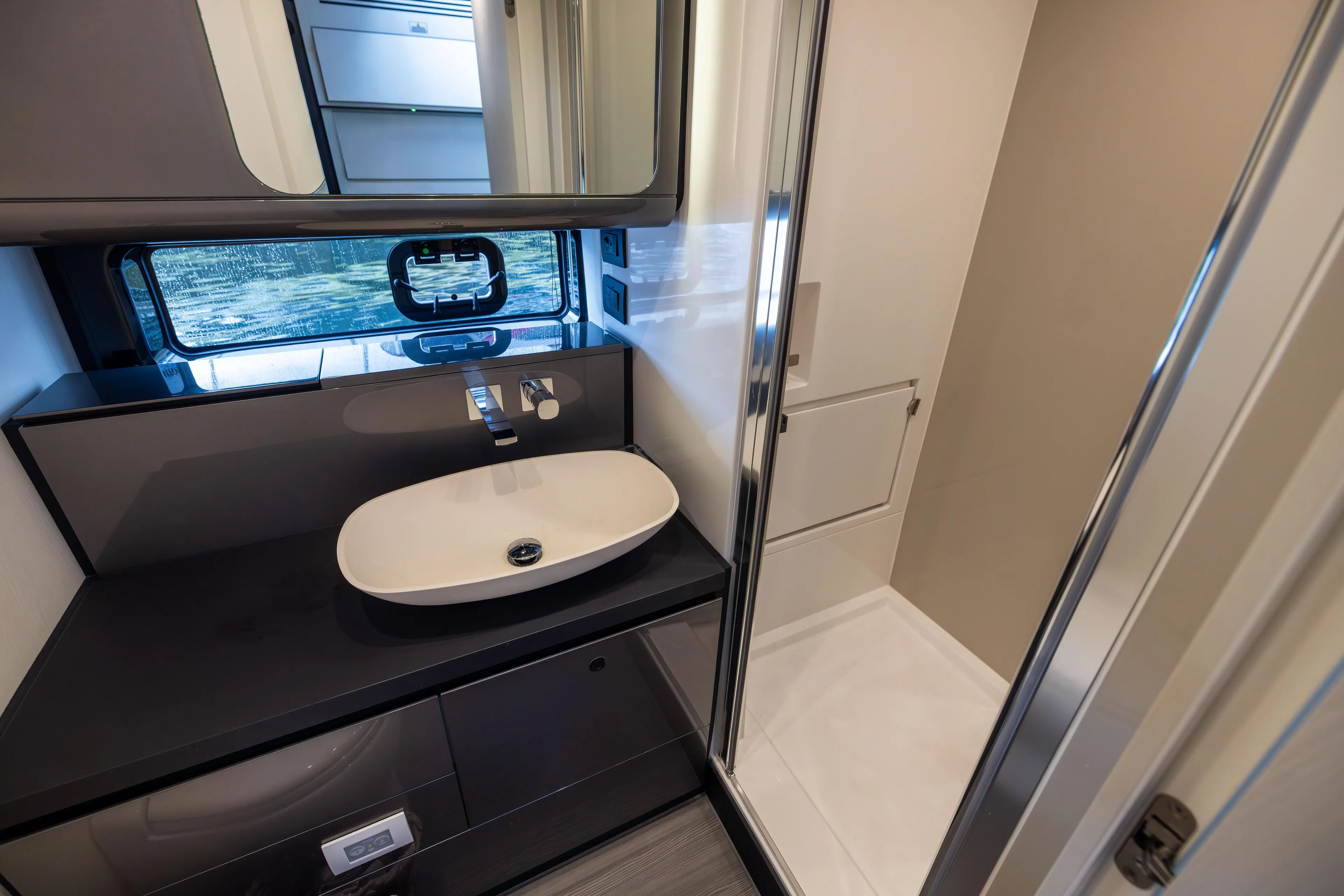  Yacht Photos Pics Luxurious bathroom in 2022 Azimut Verve 47 yacht, featuring modern sink and shower.