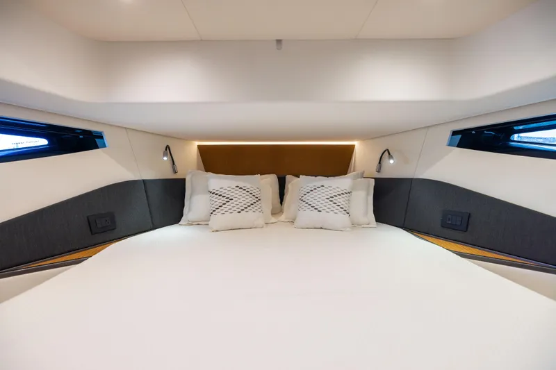  Yacht Photos Pics Luxurious bedroom interior of 2022 Azimut Verve 47 yacht with modern design and cozy bedding.