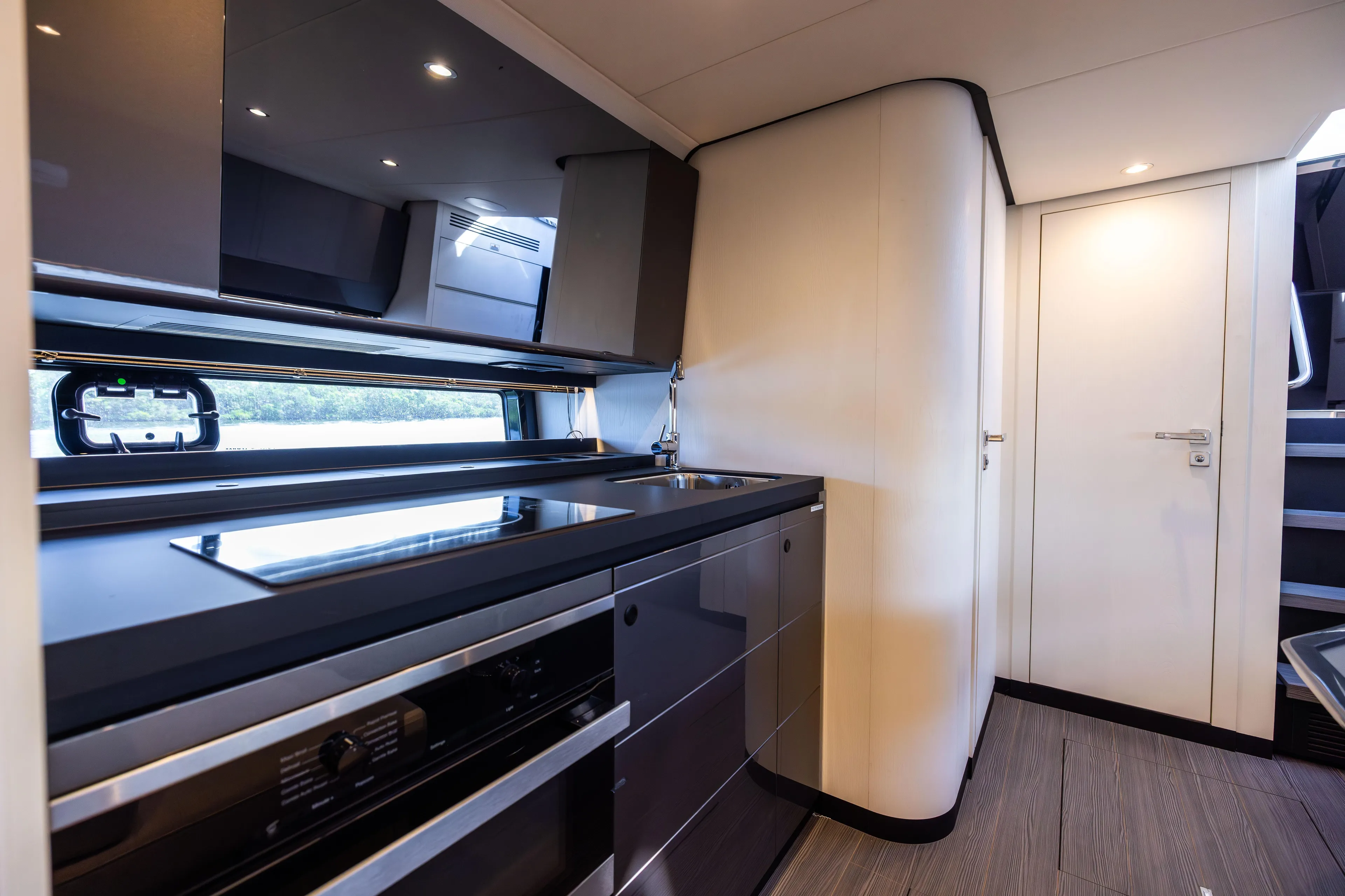  Yacht Photos Pics Modern kitchen interior of 2022 Azimut Verve 47 yacht, featuring sleek cabinetry and appliances.