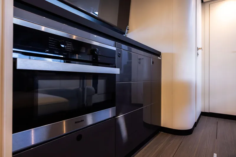  Yacht Photos Pics Modern kitchen interior on 2022 Azimut Verve 47 yacht, featuring sleek cabinetry and built-in appliances.