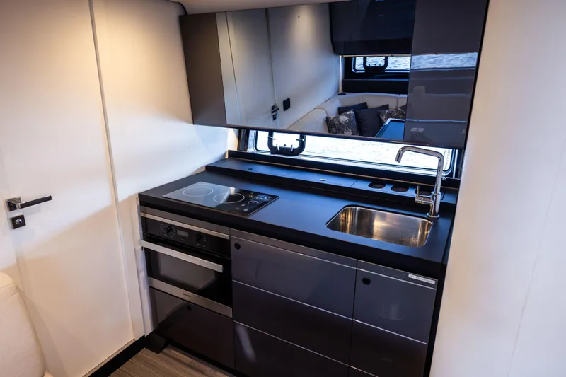  Yacht Photos Pics Modern kitchen interior of 2022 Azimut Verve 47 yacht with sleek cabinetry and appliances.