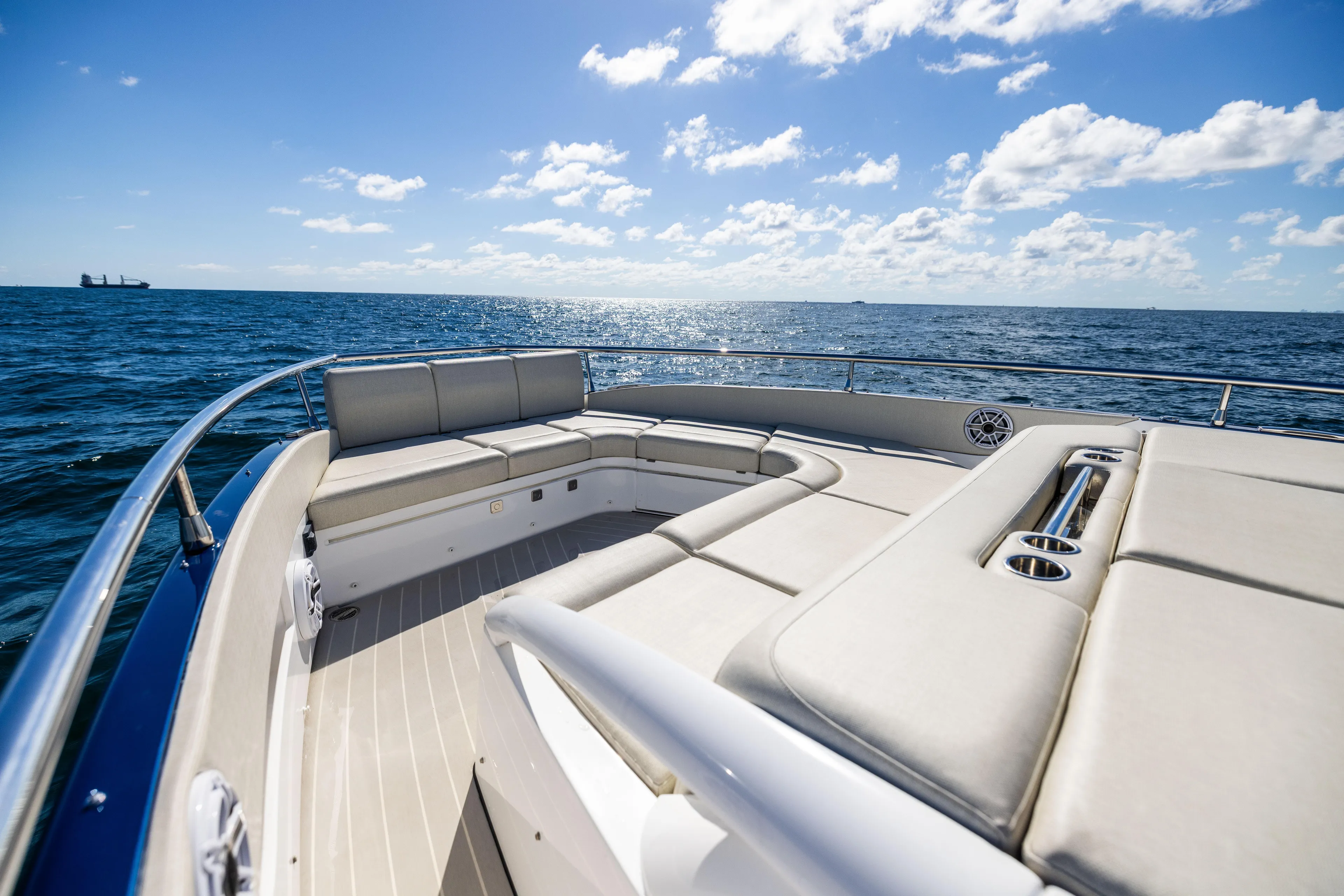 Yacht Photos Pics 2022 Azimut Verve 47 yacht deck with luxurious seating, ocean view, and clear blue sky.