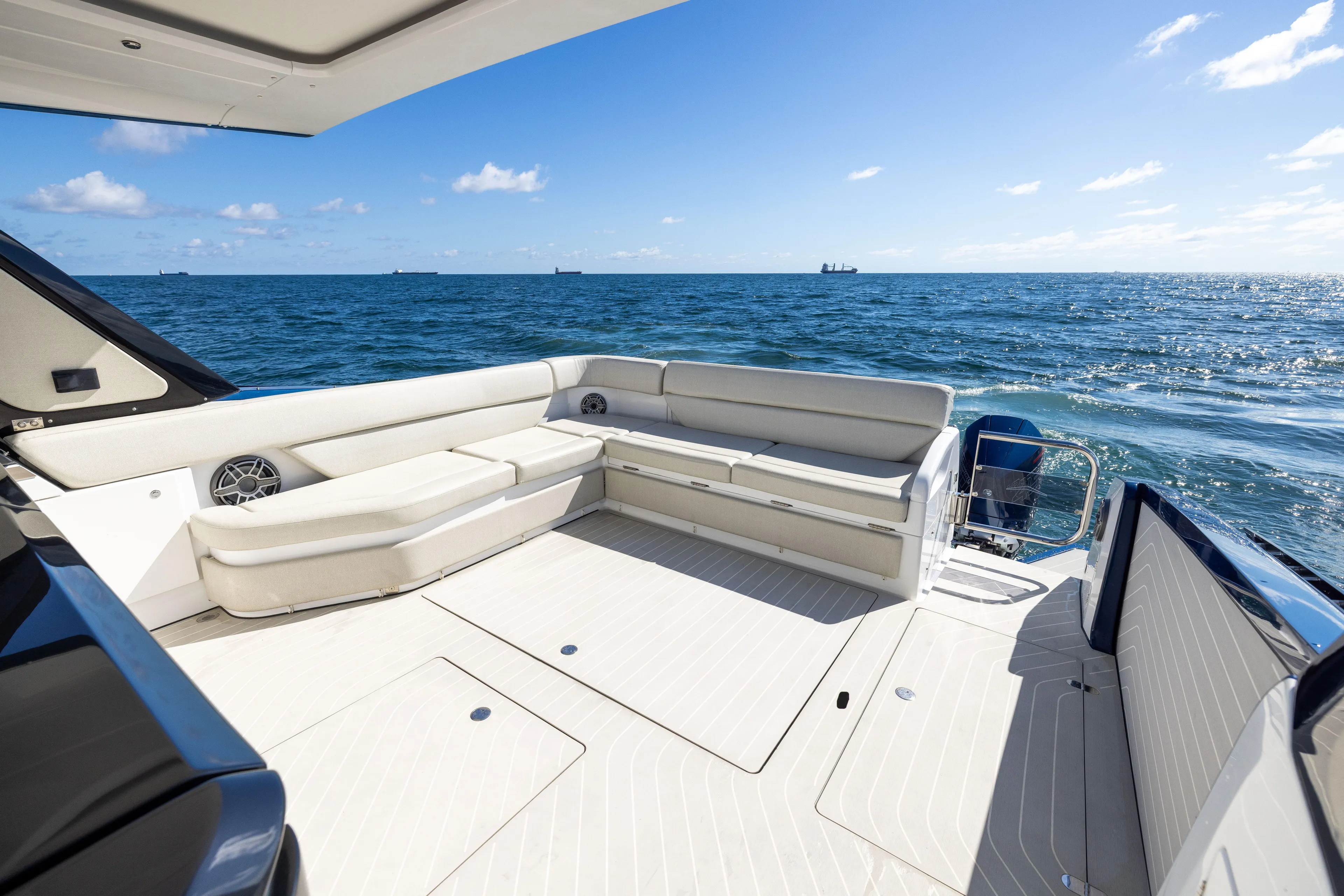  Yacht Photos Pics 2022 Azimut Verve 47 yacht deck with luxurious seating, ocean view, and clear blue sky.