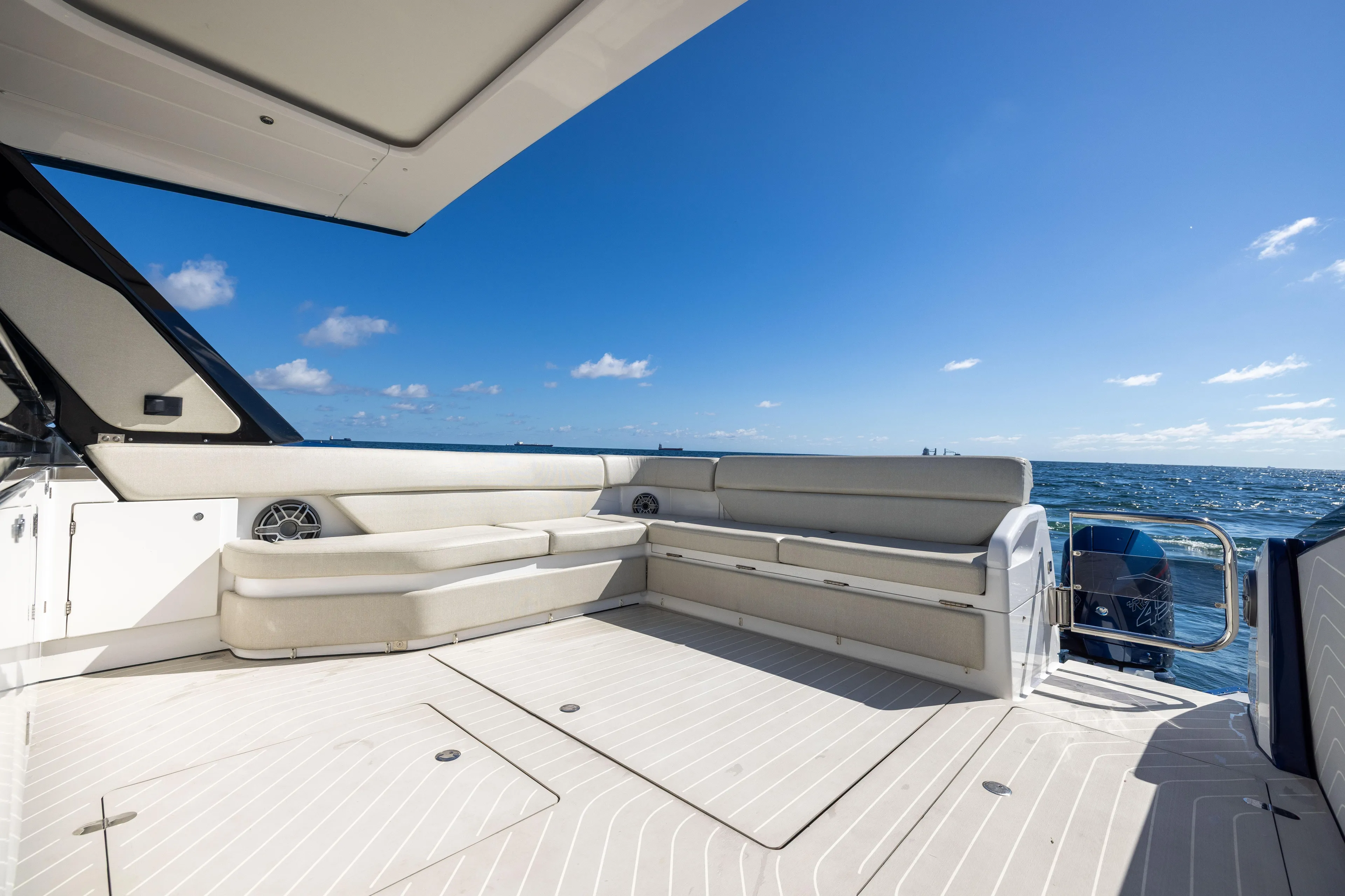  Yacht Photos Pics 2022 Azimut Verve 47 yacht deck with seating, ocean view, and clear blue sky.