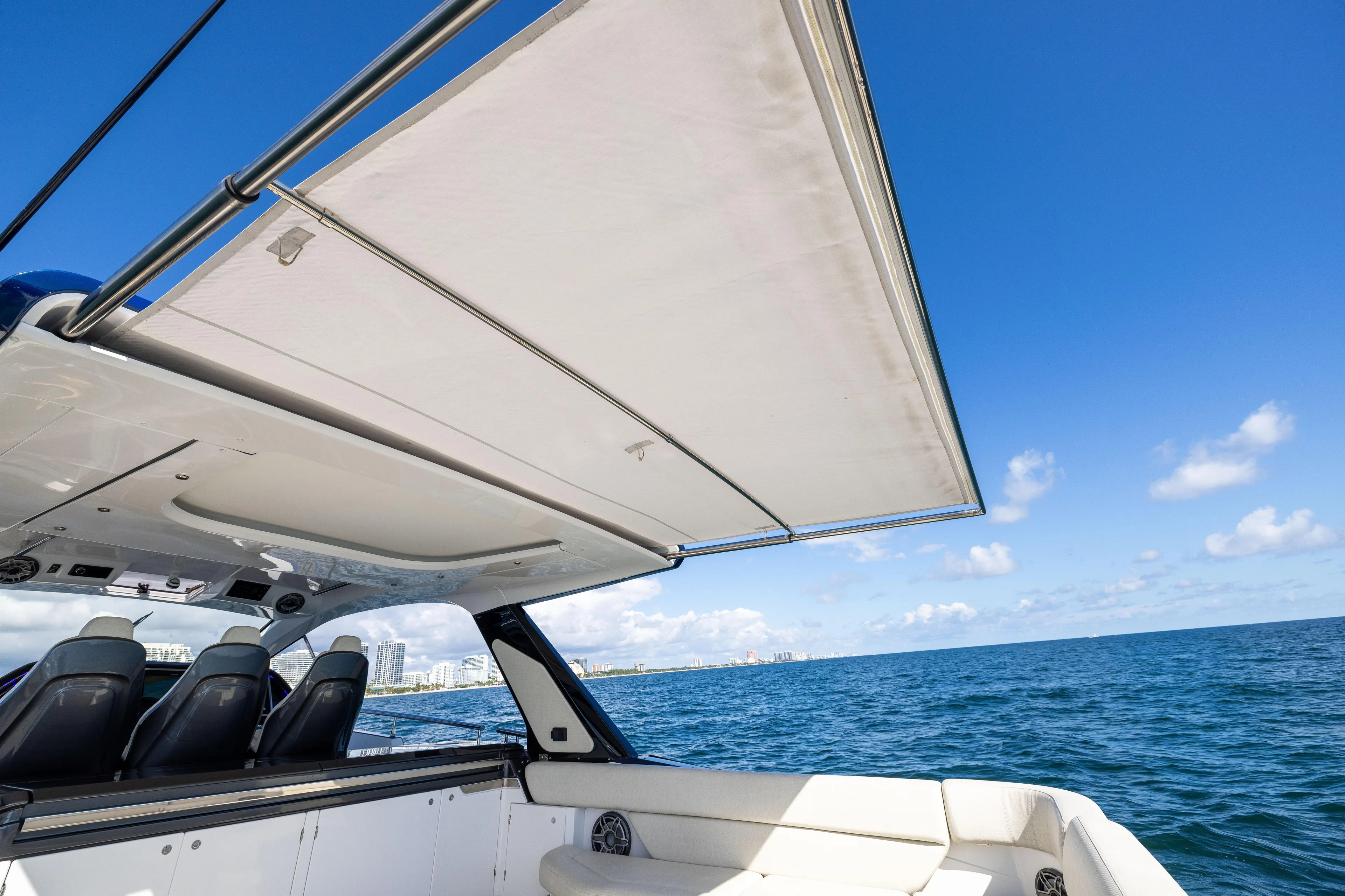  Yacht Photos Pics 2022 Azimut Verve 47 yacht with sunshade, ocean view, and clear blue sky.