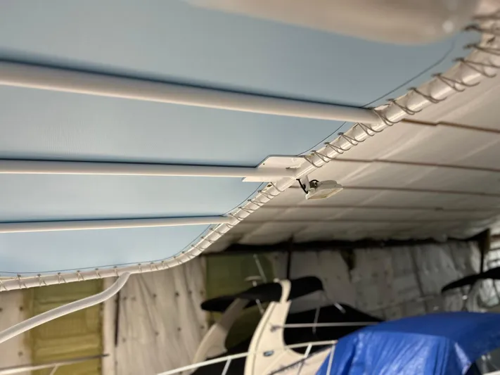  Yacht Photos Pics 2007 Donzi 38 ZF Cuddy boat interior with blue canopy and metal framework.