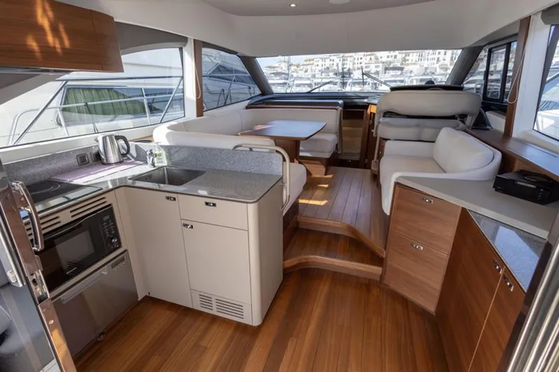 Yacht Photos Pics Luxurious interior of a 2021 Princess F45 yacht with modern kitchen and seating area.