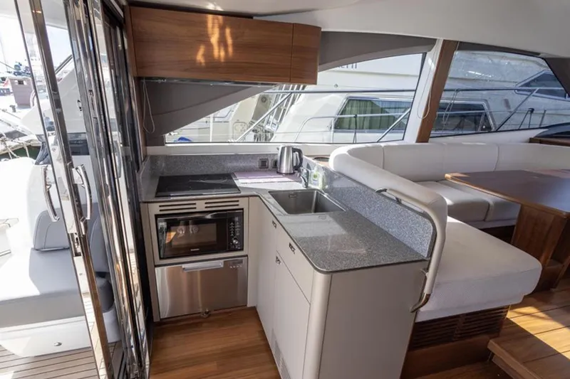  Yacht Photos Pics Modern kitchen interior on 2021 Princess F45 yacht with sleek countertops and appliances.