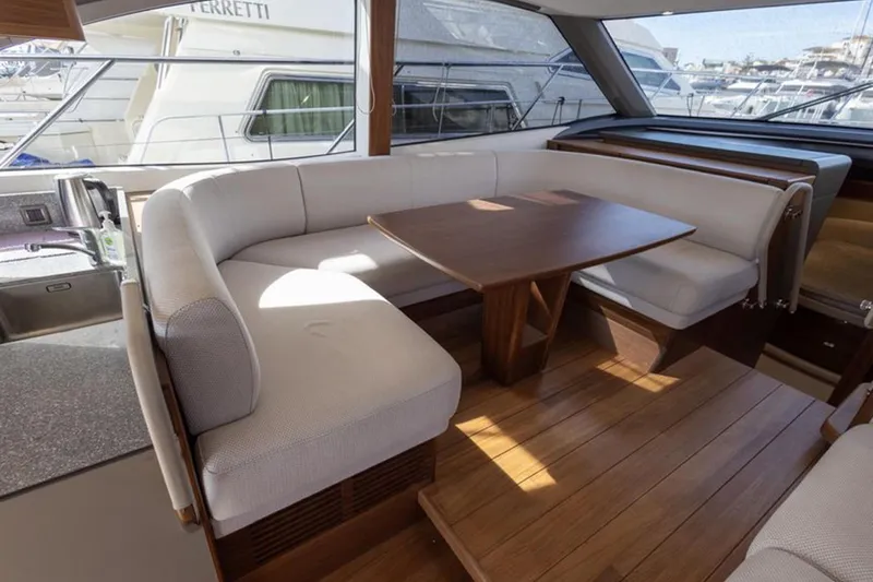  Yacht Photos Pics Luxurious interior of 2021 Princess F45 yacht with elegant seating and wooden table.