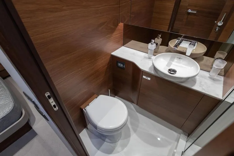  Yacht Photos Pics Luxurious bathroom in 2021 Princess F45 yacht with modern fixtures and wooden accents.