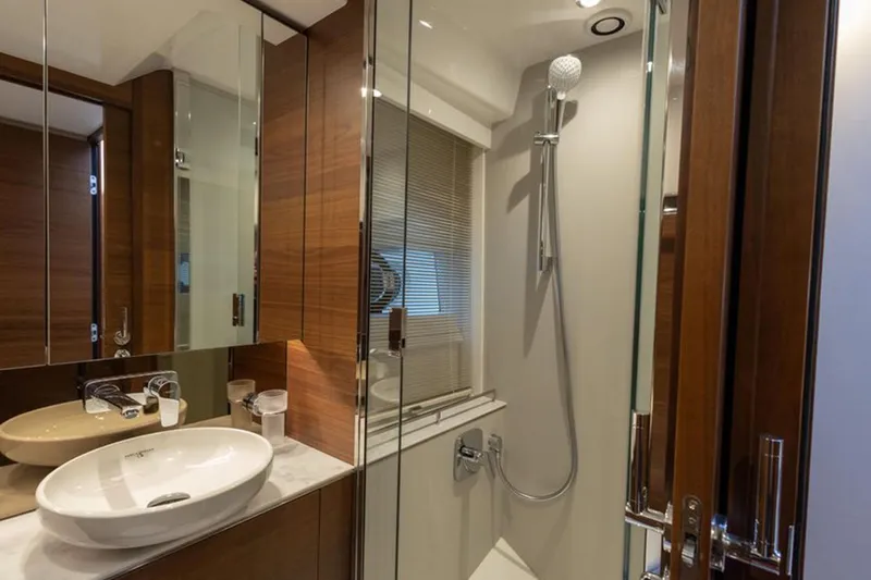  Yacht Photos Pics Luxurious bathroom in 2021 Princess F45 yacht with modern fixtures and elegant wood accents.