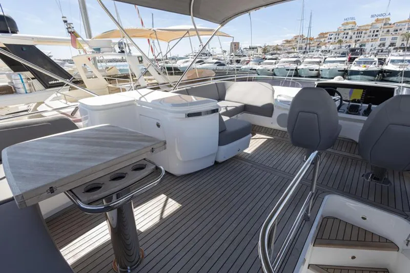  Yacht Photos Pics Luxurious 2021 Princess F45 yacht deck with seating and table, docked at a marina.