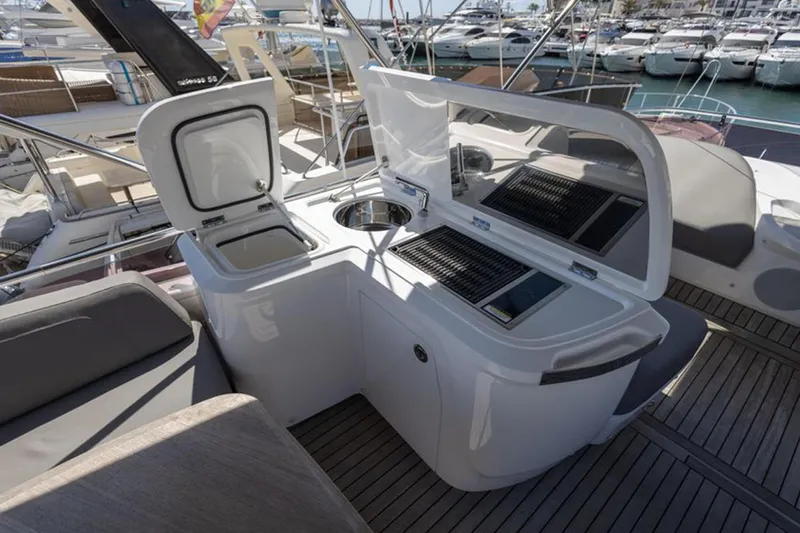  Yacht Photos Pics Outdoor kitchen on 2021 Princess F45 yacht with grill and sink, docked at marina.