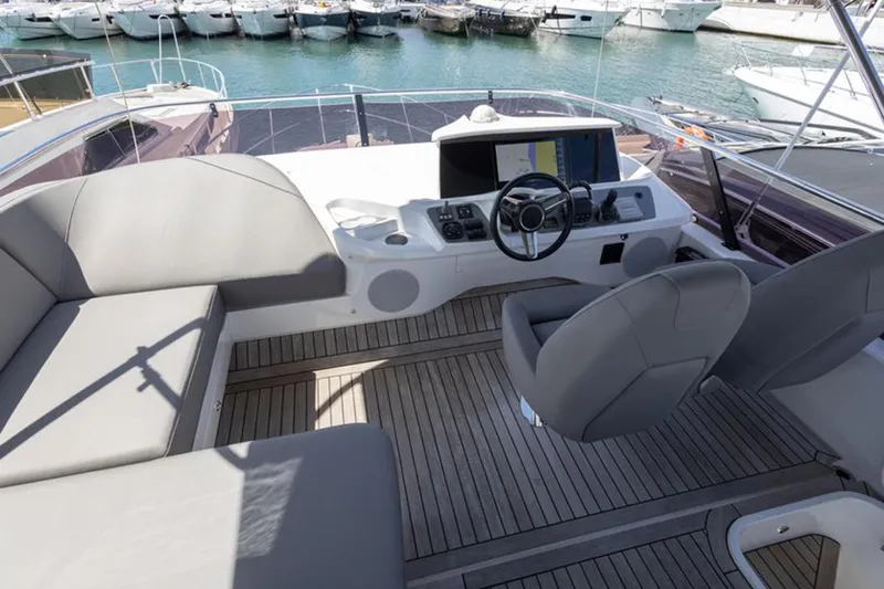  Yacht Photos Pics Luxurious 2021 Princess F45 yacht cockpit with modern steering and seating, docked at marina.