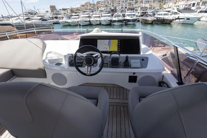  Yacht Photos Pics Flybridge of 2021 Princess F45 yacht with helm, steering wheel, and marina view.