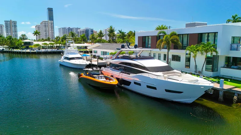  Yacht Photos Pics Luxury yachts docked by waterfront homes, featuring a 2022 Midnight Express 43 Open.