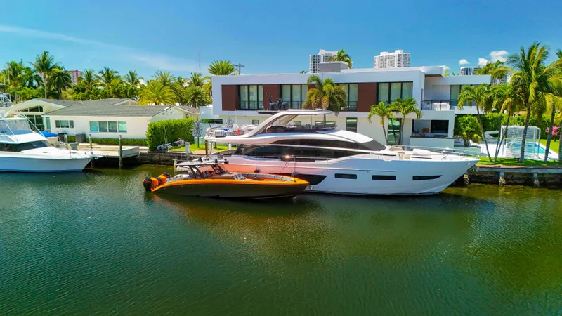  Yacht Photos Pics Luxury waterfront home with a 2022 Midnight Express 43 Open yacht docked nearby.