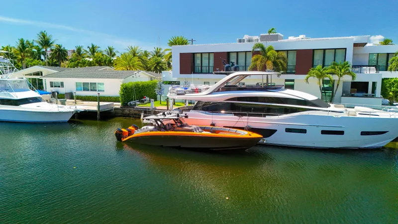  Yacht Photos Pics 2022 Midnight Express 43 Open yacht docked beside luxury waterfront homes.