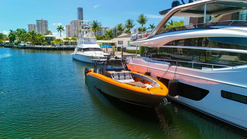  Yacht Photos Pics 2022 Midnight Express 43 Open boat docked beside luxury yachts in a sunny marina.