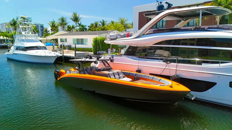  Yacht Photos Pics 2022 Midnight Express 43 Open boat docked beside luxury yachts in a sunny marina.