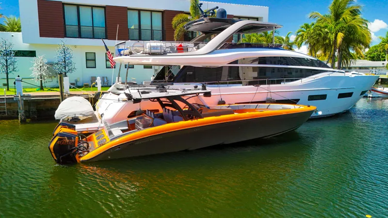 Yacht Photos Pics 2022 Midnight Express 43 Open boat docked beside a luxury yacht in a sunny marina.